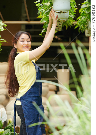 Woman working at gardening center 77690132