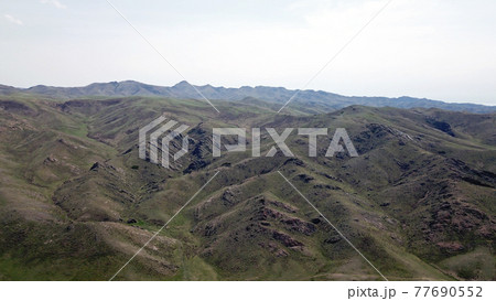 View of green hills and gorges with rocks. View of green hills and gorges with rocks. 77690552