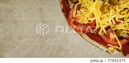 Pizza with beef on baking paper prepared for baking. Cooking at home. Banner Pizza with beef on baking paper prepared for baking. Cooking at home. Banner 77692375