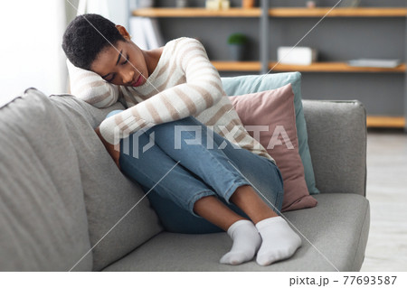 Depression Concept. Portrait Of Sad African Female Sitting On Sofa At Home 77693587