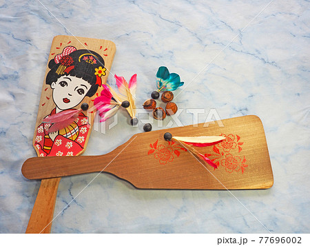 お正月の遊び羽根突きの羽子板とムクロジの種の羽根の写真素材