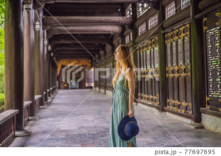 Woman tourist in Temple tower of Bai Dinh pagoda in Ninh Binh, Vietnam. Resumption of tourism in Vietnam after quarantine Coronovirus COVID 19 77697695