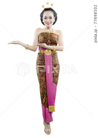 Asian woman with Java traditional dance costume showing something 77698502