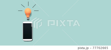 Smartphone with a yellow light bulb 77702665