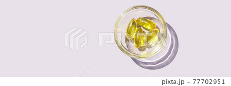 Omega3 gel capsule. Sun shadow. Yellow vitamin. Health eating. Dietology drug Omega3 gel capsule. Sun shadow. Yellow vitamin. Health eating. Dietology drug 77702951