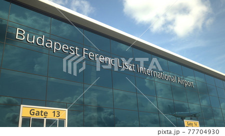 Landing airplane reflects in the modern windows with Budapest Ferenc Liszt International Airport text. 3d rendering 77704930