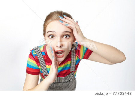 attractive girl put her hands to her head. advertising concept. photo shoot on a white background attractive girl put her hands to her head. advertising concept. photo shoot on a white background 77705448