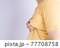 Fat man holding excessive fat boobs isolated grey background. 77708758