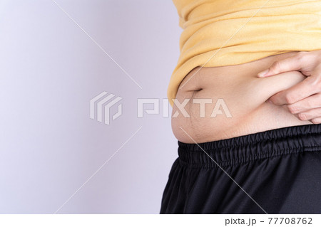 Fat man holding excessive fat belly isolated grey background. Fat man holding excessive fat belly isolated grey background. 77708762
