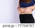 Fat woman holding excessive fat belly isolated grey background. 77708767