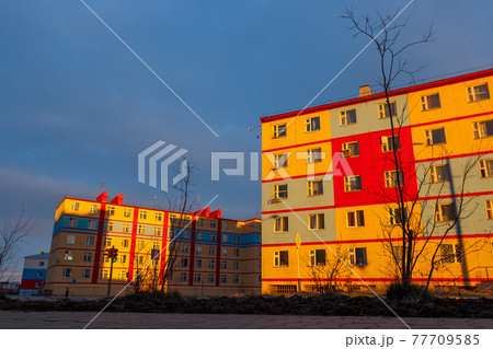 Colorful residential buildings at sunset. 77709585
