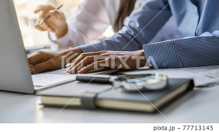 Young unemployed is searching for a job in the newspaper and laptop. Interview the job and hiring concept. Young unemployed is searching for a job in the newspaper and laptop. Interview the job and hiring concept. 77713145