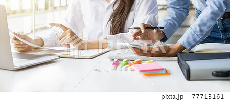 Young unemployed is searching for a job in the newspaper and laptop. Interview the job and hiring concept. Young unemployed is searching for a job in the newspaper and laptop. Interview the job and hiring concept. 77713161