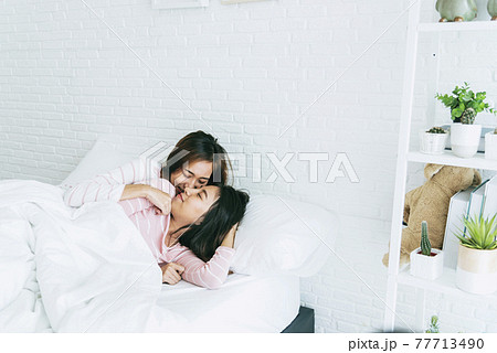 Lesbian couple homosexual happiness lifestyle on bed. Two pretty girlfriend talk, hug and laugh together relation fall in love. LGBTQ relation lifestyle concept. Lesbian couple homosexual happiness lifestyle on bed. Two pretty girlfriend talk, hug and laugh together relation fall in love. LGBTQ relation lifestyle concept. 77713490