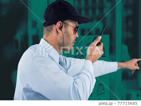 Composition of male security guard using walkie talkie holding hand out over green background 77715685