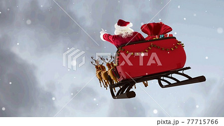 Composition of santa claus in sleigh pulled by reindeer on snowfall and clouds background 77715766