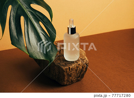 Bottle of cosmetic product oil serum pastel brown background abstract podium Bottle of cosmetic product oil serum pastel brown background abstract podium 77717280