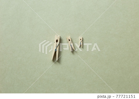 Wooden clip on khaki background. top view, copy space 77721151