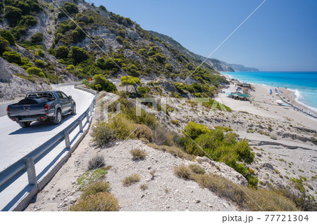 Tourist car on the coast road to beach on Lefkada Ionian island, Greece 77721304