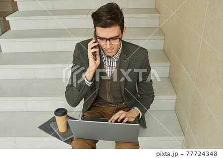 Businessman working online on laptop Businessman working online on laptop 77724348