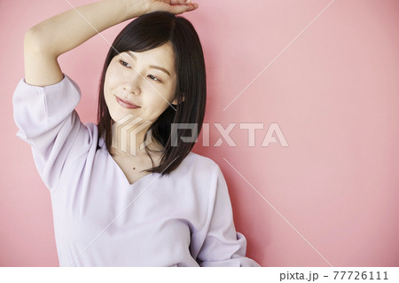 Beautiful asian woman on pink background 77726111