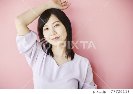 Beautiful asian woman on pink background 77726113