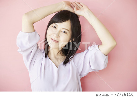 Beautiful asian woman on pink background 77726116