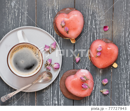 heart shaped mousse cakes with dry roses and a cup of coffee. romantic breakfast. valentine's and wedding concept. love and couple relationship. 77727943
