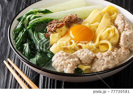 Ban Mian Chinese egg noodle soup with anchovies, meatballs and pak choi close-up in a bowl. horizontal Ban Mian Chinese egg noodle soup with anchovies, meatballs and pak choi close-up in a bowl. horizontal 77730581