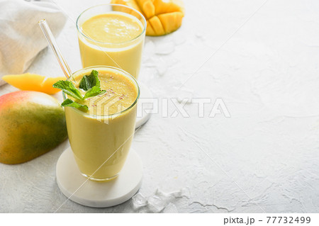 Indian mango or turmeric lassi on gray background 77732499