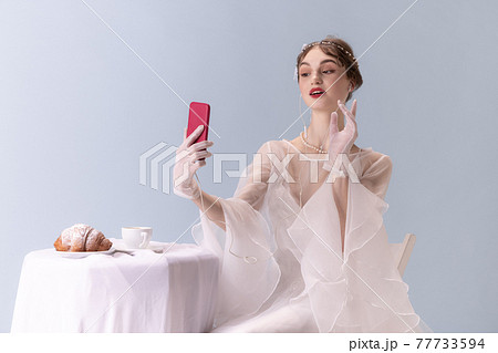 Young woman in art action isolated on white background. Retro style, comparison of eras concept. Young woman in art action isolated on white background. Retro style, comparison of eras concept. 77733594
