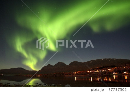 Green aurora borealis over the night sky of Norway 77737502