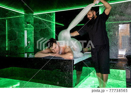 Man on the procedure of the foam massage in the hammam Man on the procedure of the foam massage in the hammam 77738565