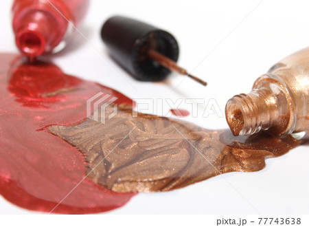 Gold and Copper Metallic Nail polish on White 77743638