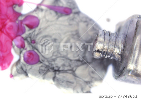 Pink and Silver Nail polish Spilled on White 77743653
