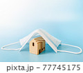 Business, finance, real estate, family health protection, stay home, Covid-19 lockdown or mortgage crisis concept : Wood house model cover by surgical mask with copy space ready for adding or mock up 77745175