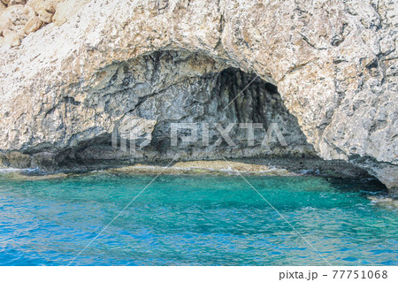 Large cave washed by the sea in a rock in Cyprus 77751068