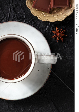 Hot chocolate close-up on a black background Hot chocolate close-up on a black background 77751180