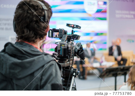 Cameraman shooting video and broadcasting conference Cameraman shooting video and broadcasting conference 77753780