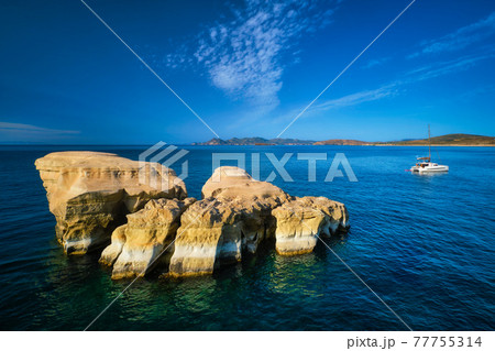 Yacht boat at Sarakiniko Beach in Aegean sea, Milos island , Greece 77755314