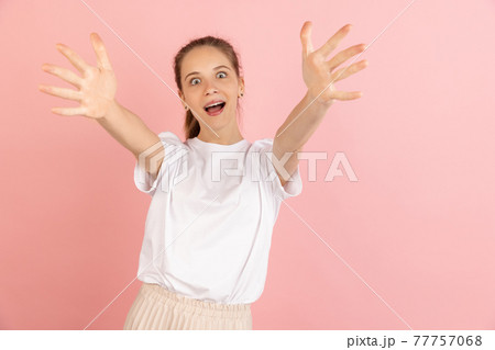 Caucasian young woman's portrait isolated over pink studio background with copyspace Caucasian young woman's portrait isolated over pink studio background with copyspace 77757068