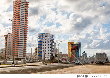 Modern resedential buildings close to Malecon promenade and road with cars, Vedado, Havana, Cuba 77757278