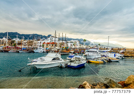 Kyrenia or Girne  historical city center, view to marina with many yachts and boats with mountains in the background, North Cyprus 77757379