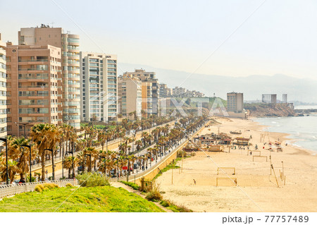 Seaside promenade with modern building, road, sandy beach and sea, Beirut, Lebanon 77757489
