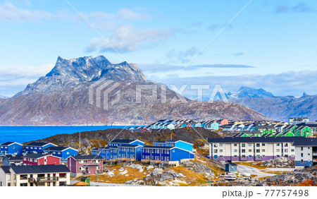 Inuit houses and cottages scattered across tundra landscape in residential suburb of Nuuk city with fjord and mountains in the background, Greenland Inuit houses and cottages scattered across tundra landscape in residential suburb of Nuuk city with fjord and mountains in the background, Greenland 77757498
