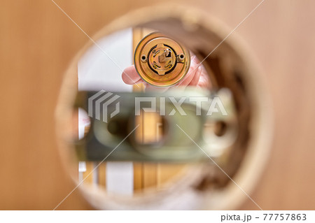 Assembling door lock with knob and latch, inserting bolt into assembly mechanism. Assembling door lock with knob and latch, inserting bolt into assembly mechanism. 77757863