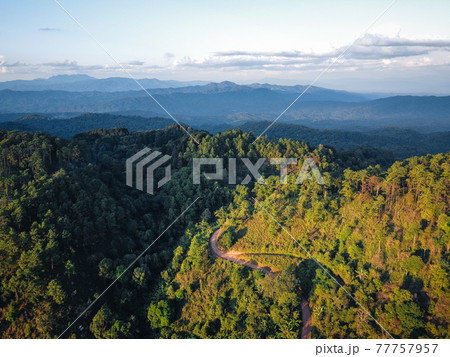 Road through a valley from above 77757957
