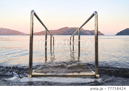 Dawn landscape of the beach with pier going into the sea. Calm idyllic seascape. Zen harmony concept 77758424