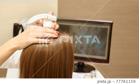 Woman check head hair in clinic. 77761159
