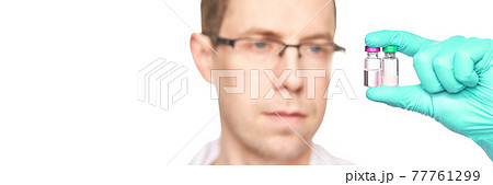 Male person in green glove hold vaccine bottles. Injection drug pharmacy concept Male person in green glove hold vaccine bottles. Injection drug pharmacy concept 77761299